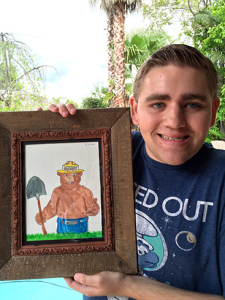 Ethan holding up his framed drawing of Smokey the Bear
